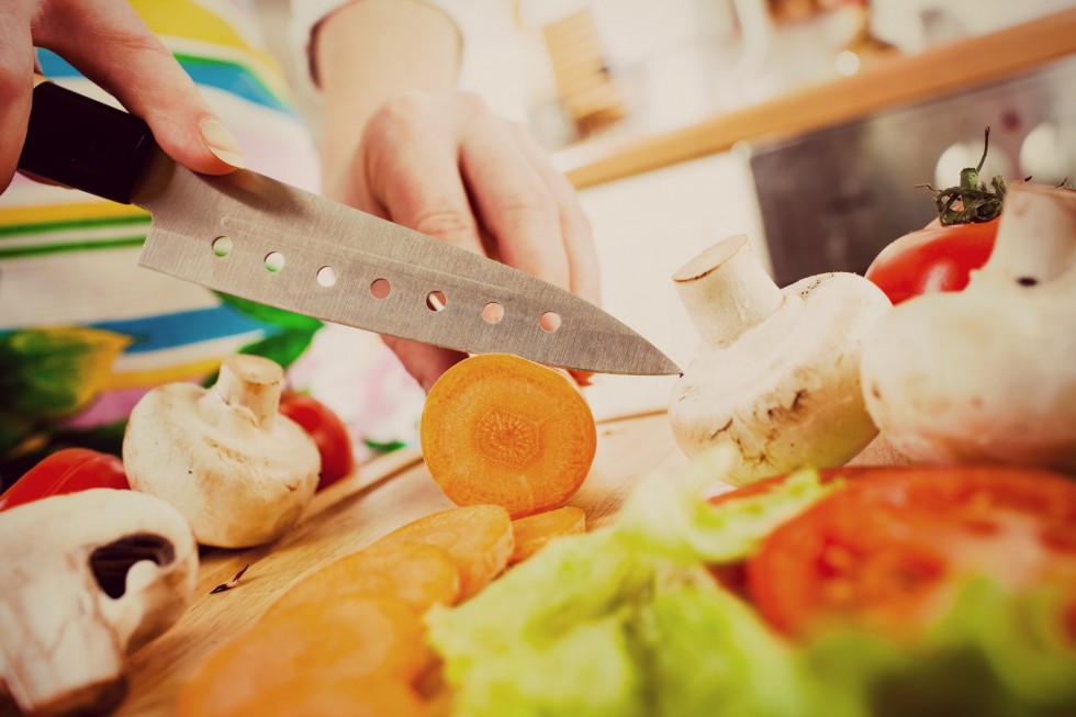 bigstock-Woman-s-hands-cutting-carrot-edited
